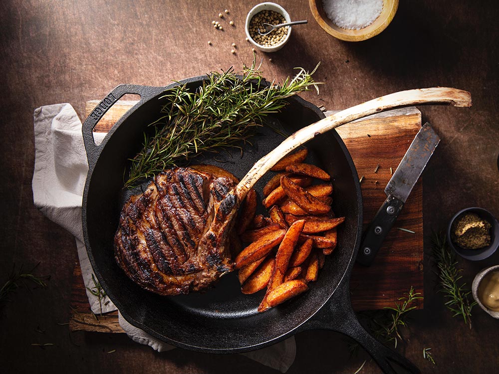 Slow Cooker Beef Bourguignon in a white bowl with parsley.